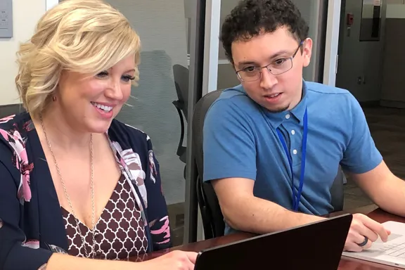 biBerk IT person helping other employee