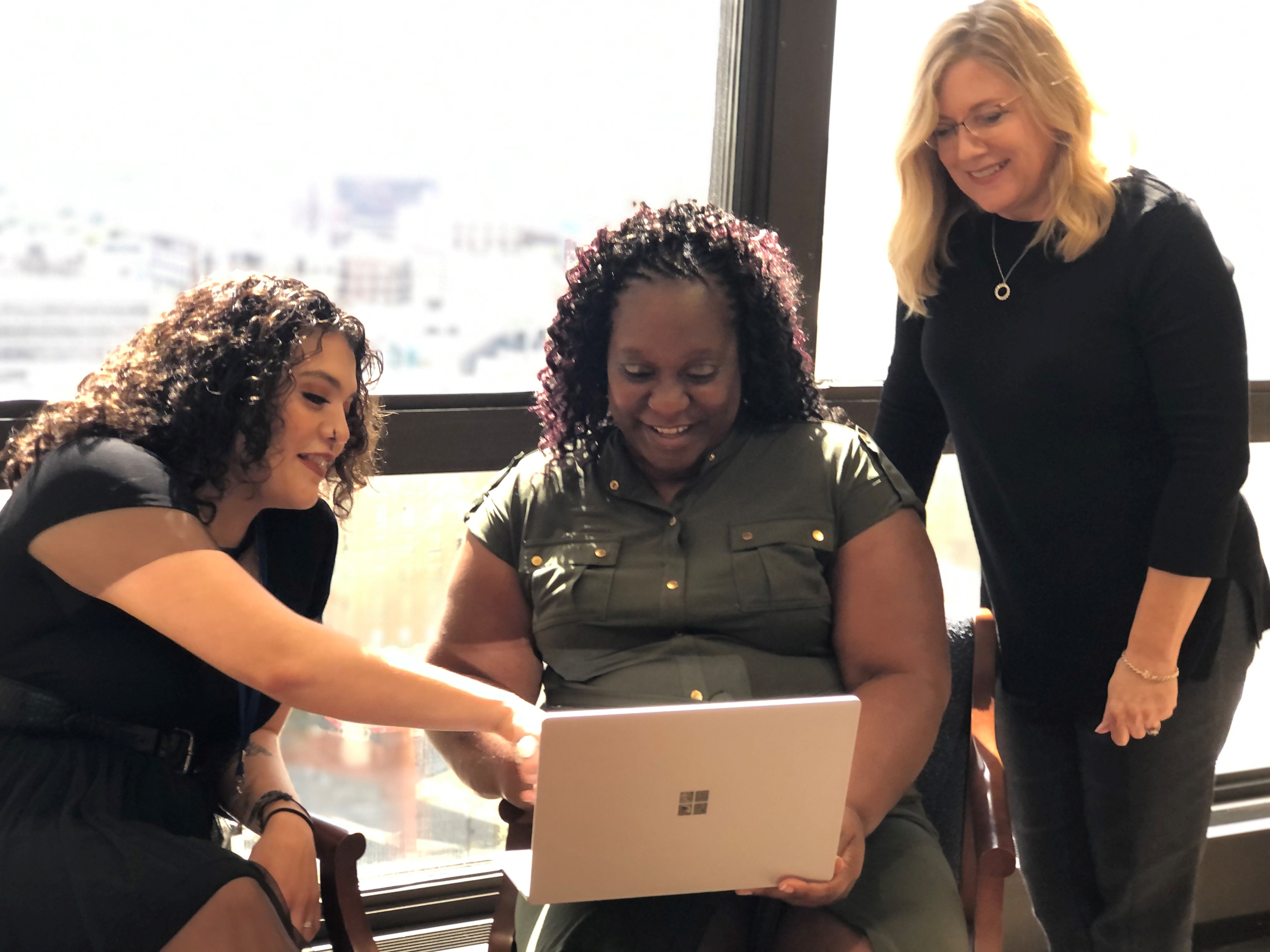 biBerk employees looking at laptop