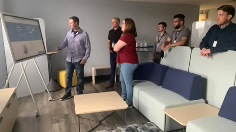 biBerk employees watching a presentation