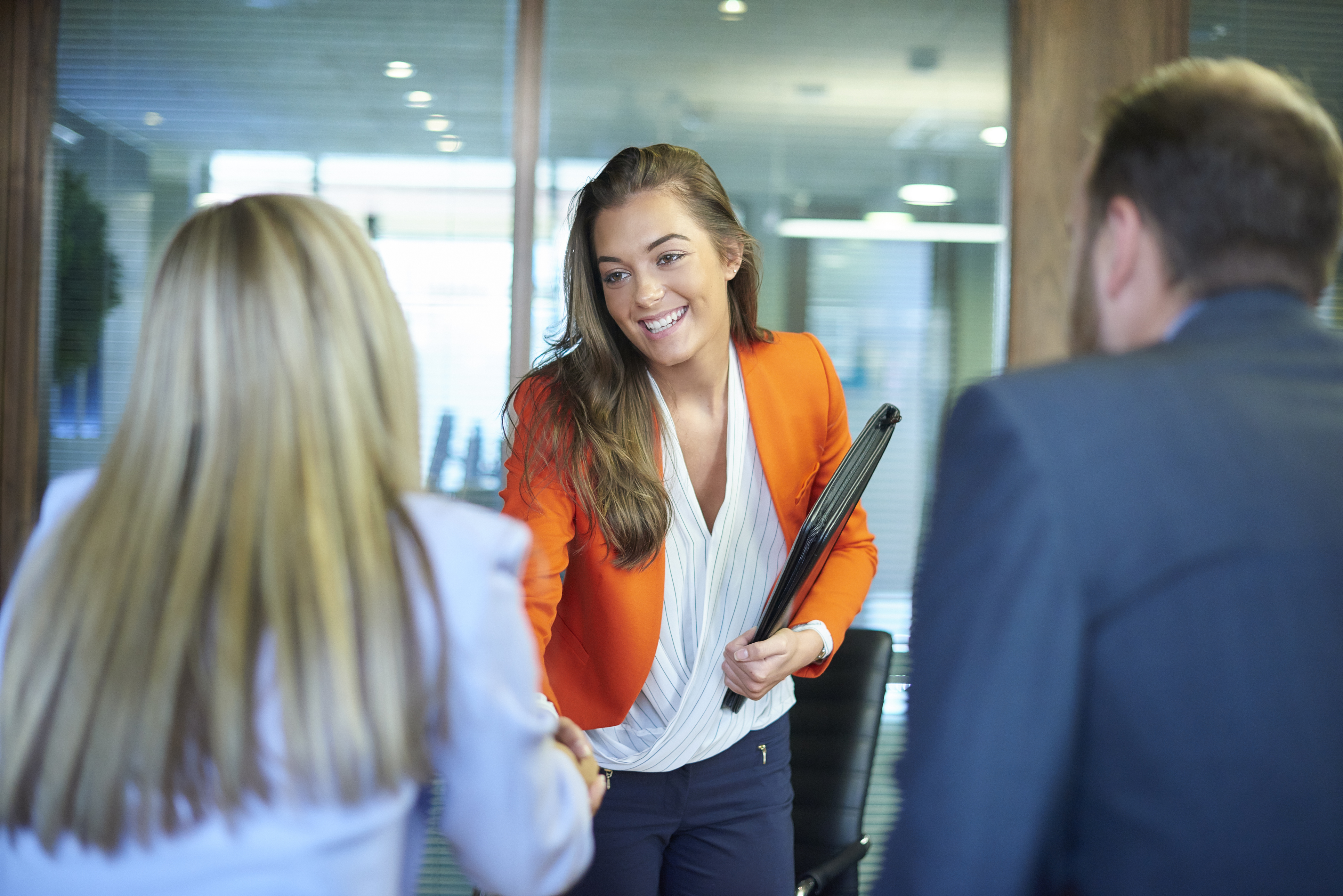 Woman shaking hands with client